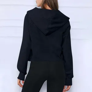 Vista posteriore di una felpa corta nera scuba con mezza zip per yoga e fitness femminile