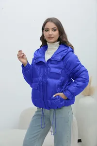 Detailed view of women's vibrant blue thickened puffer jacket with multiple pockets