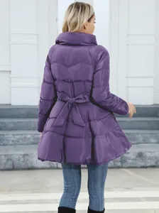 Back view of purple mid-length puffer jacket with waist bow tie and stand collar