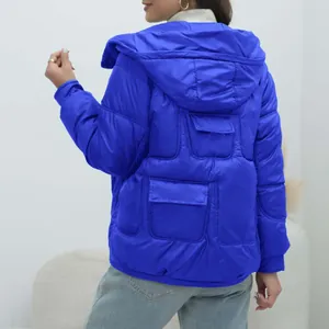 Back view detail of royal blue hooded thick puffer jacket for women featuring unique pockets