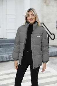 Detailed view of a grey plus size women's winter puffer jacket with high collar design