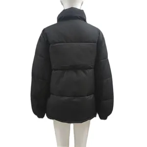 Back view detail of a black quilted women's winter puffer jacket on a white mannequin