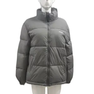Detailed view of the zip-up front and high stand collar on a gray winter puffer jacket