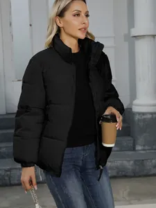 Stylish women's black puffer jacket for winter warmth in urban outdoor setting