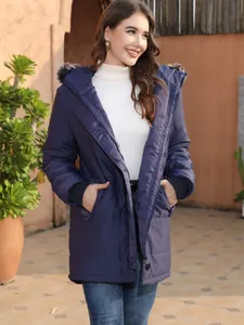 Stylish women's navy blue mid-length hooded parka with faux fur trim in outdoor setting