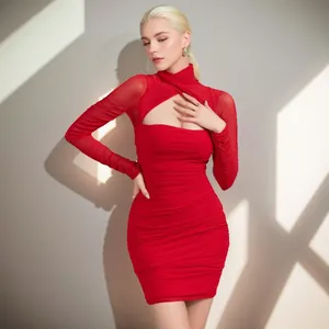 Beautiful model posing in a sexy red ruched mesh dress with chic front cut-out details