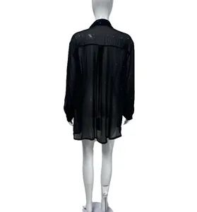 Back view of a fashionable black long-sleeved sheer shirt with shimmering sequin details