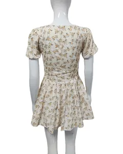 Back view of a French vintage floral mini dress with puff sleeves and pleated skirt