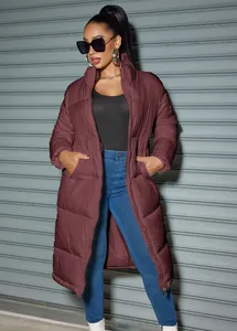 Detailed view of women's long burgundy puffer coat featuring zipper closure and side pockets