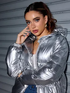 Detail view of a trendy silver metallic shiny puffer jacket with a hood for winter wear