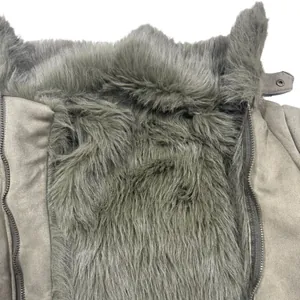 Detail shot of grey suede biker jacket showing soft faux fur lining and sturdy zippers.