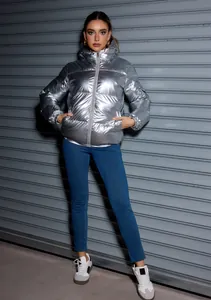 Model wearing a metallic silver hooded puffer jacket highlighting the shiny fabric texture