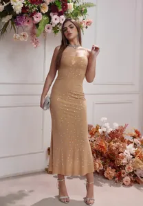 Elegante vestido de noche champán con pedrería y tirantes finos de corte ajustado.