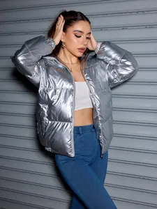 Metallic silver puffer jacket detail worn by a stylish model against a metal background
