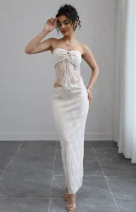 Elegant white lace two-piece set featuring a sheer tube top and a long matching skirt.