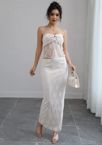 Elegant white lace two-piece set featuring a sheer tube top and matching long maxi skirt
