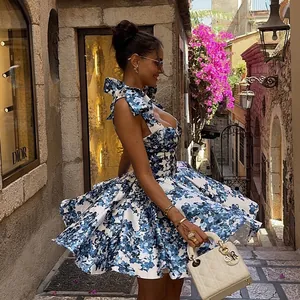 Elegant blue and white floral mini dress with bow straps for summer vacation style