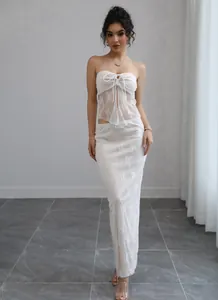 Elegant white floral lace two-piece set featuring a sheer tube top and matching maxi skirt