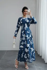 Full-length view of blue floral maxi dress with long sleeves and tiered skirt