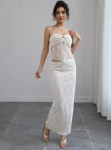 Elegant white lace two-piece set featuring a tube top and long skirt for vacation.