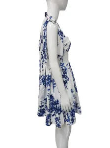 Side profile detail of the elegant white and blue floral print vacation dress on a mannequin