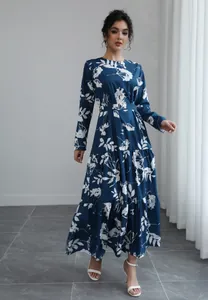 Detailed view of an elegant blue long-sleeved floral maxi dress featuring a waist tie