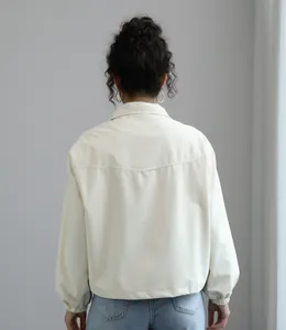 Detailed back view of a minimalist cream waterproof short jacket with stand collar