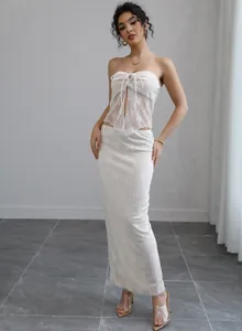 Exquisite detail of a luxury white lace tube top and long skirt two-piece set on a model