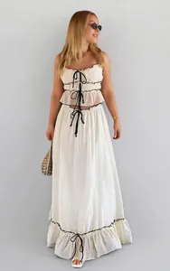 Detailed view of women's summer two-piece set with bow-knot top and ruffled skirt