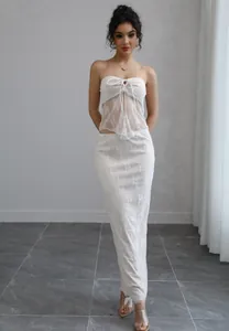 Detailed visual of a white floral lace strapless top and matching long maxi skirt set