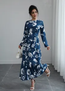 Full-length detail of elegant blue long-sleeve floral print maxi dress with tie waist