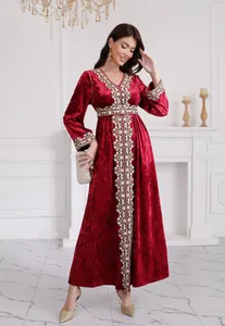 Full length view of a luxurious red velvet maxi dress with ethnic embroidery and V-neckline