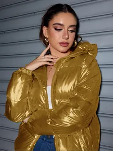 Detailed shot of a shiny metallic gold oversized hooded puffer jacket in American style.