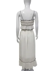 Back view of white summer two-piece set with ruffled crop top and long skirt