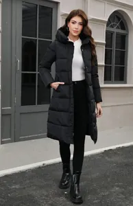 Elegant slim-fit long black hooded puffer jacket for women shown in an outdoor street setting