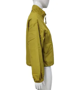 Side view detail of a mustard yellow short windbreaker jacket on mannequin