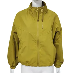 Front view of mustard yellow waterproof windbreaker with stand collar and zippers