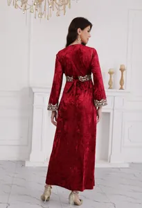 Back view of elegant red velvet maxi dress with intricate waist and cuff embroidery details
