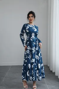 Detail view of navy blue floral long-sleeved dress with tiered hem and belt.