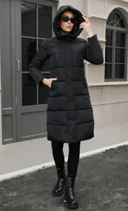 Full-body view of a slim black hooded long puffer jacket for winter