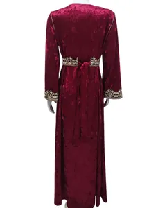 Detailed back view of a burgundy velvet maxi dress featuring gold embroidery on waist