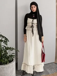 Elegant beige two-piece summer set with bow camisole and ruffled fairy maxi skirt