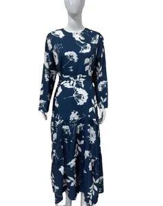 Detail view of a navy blue long-sleeved floral midi dress with a round neck and waist tie.