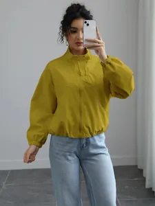 Stylish women's short waterproof windbreaker jacket with stand collar in mustard yellow