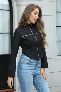 Detail view of the black motorcycle jacket's asymmetrical hem and shiny silver zip pockets.