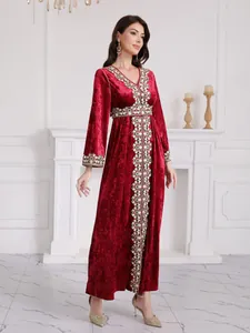 Elegant V-neck long sleeve red velvet maxi dress with intricate geometric embroidery details.