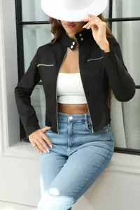 Close-up of a chic black motorcycle jacket with stand-up collar and silver zipper details