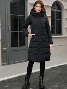 Elegant women's black long hooded puffer coat with slim fit design for cold winter