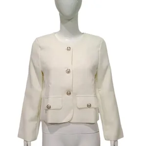 Elegant French style white tweed jacket featuring decorative gold buttons macro detail view.