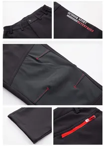 Vista detallada de los pantalones de senderismo impermeables negros con cremallera roja